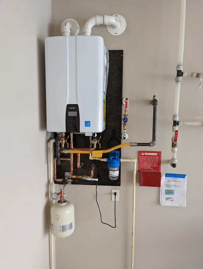 Professional plumber installing copper piping in a Minooka home